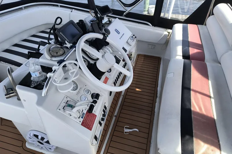 Slide: The Image of 1996 Mainship 40 Sedan Bridge helm with steering wheel, gauges, and seating. - 6