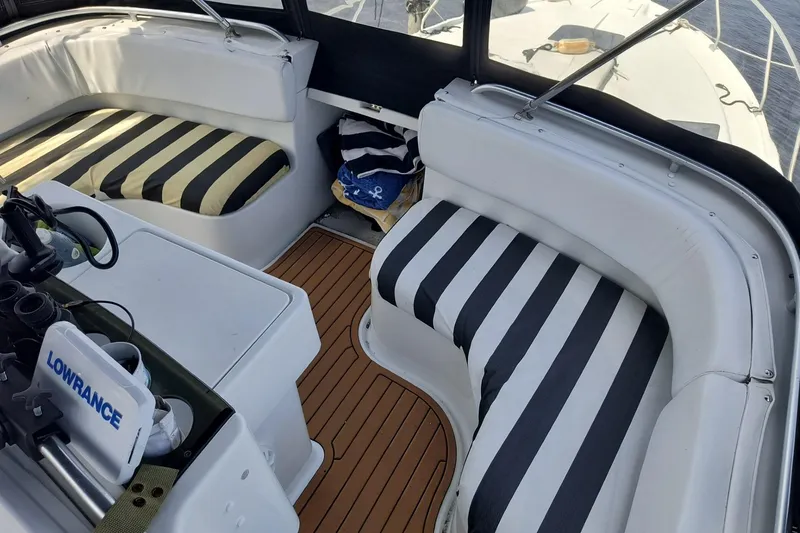Slide: The Image of Interior of 1996 Mainship 40 Sedan Bridge with striped seating and navigation equipment. - 7