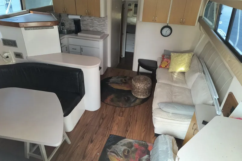 Slide: The Image of Interior of a 1996 Mainship 40 Sedan Bridge with cozy seating and kitchenette. - 9