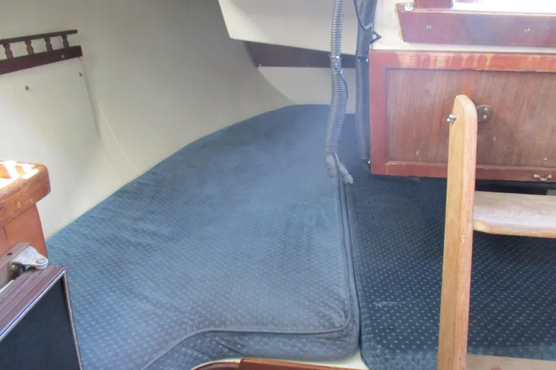 Slide: The Image of Interior cabin of a 1978 Catalina 30 sailboat with blue cushions and wooden cabinetry. - 10