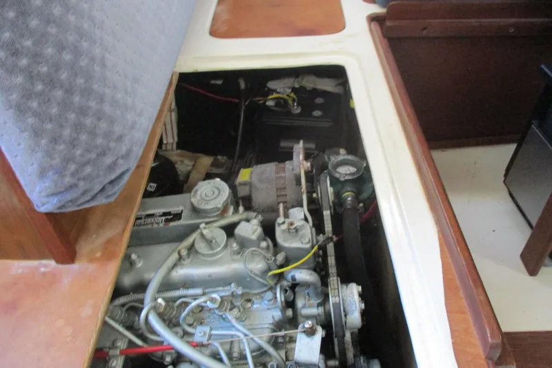 Slide: The Image of Engine compartment of a 1978 Catalina 30 sailboat, showcasing mechanical components and wiring. - 16
