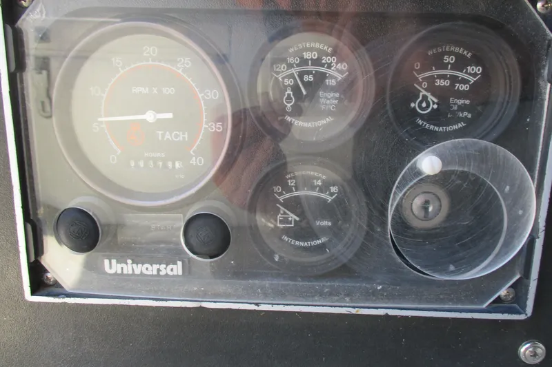 Slide: The Image of Instrument panel of a 1978 Catalina 30 sailboat, featuring tachometer and engine gauges. - 17