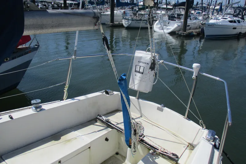 Slide: The Image of 1978 Catalina 30 sailboat cockpit view in marina, showcasing rigging and safety equipment. - 3