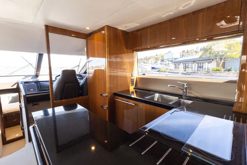 Slide: The Image of Interior of Princess 64 Flybridge Yacht, kitchen with modern amenities. - 15