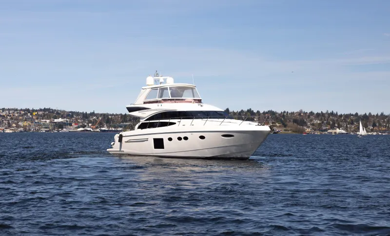 Slide: The Image of 2014 Princess 64 Flybridge Motor Yacht on calm waters. - 2