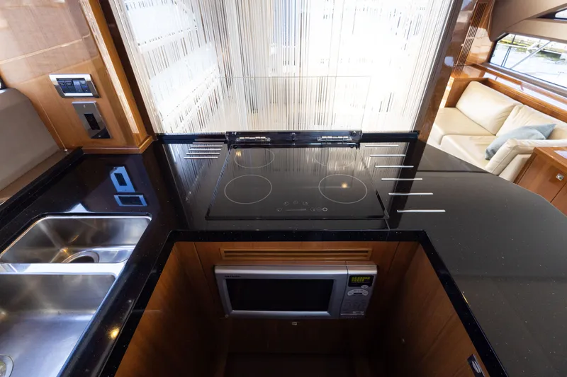 Slide: The Image of Princess 64 Flybridge Yacht 2014 kitchen with stove and microwave. - 20