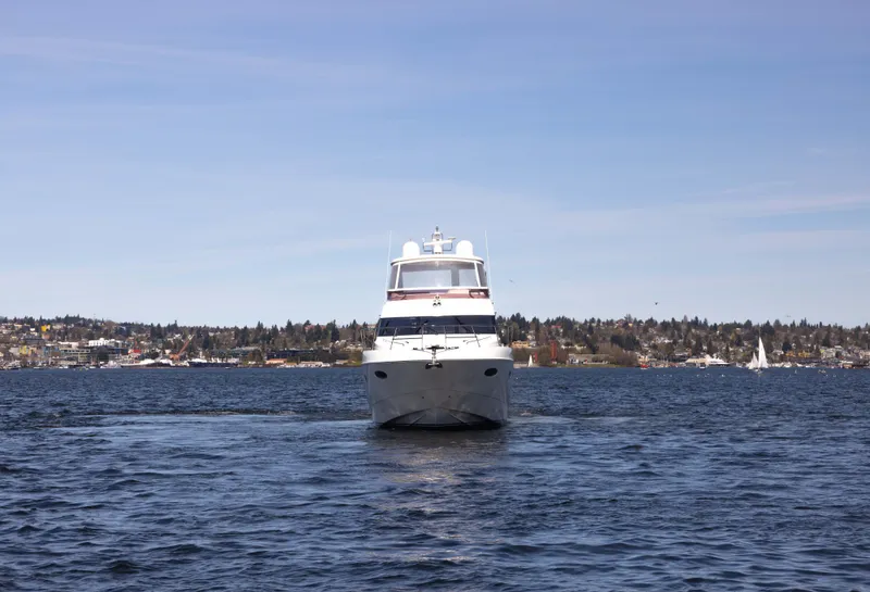 Slide: The Image of 2014 Princess 64 Flybridge Motor Yacht on water near coastal town. - 5