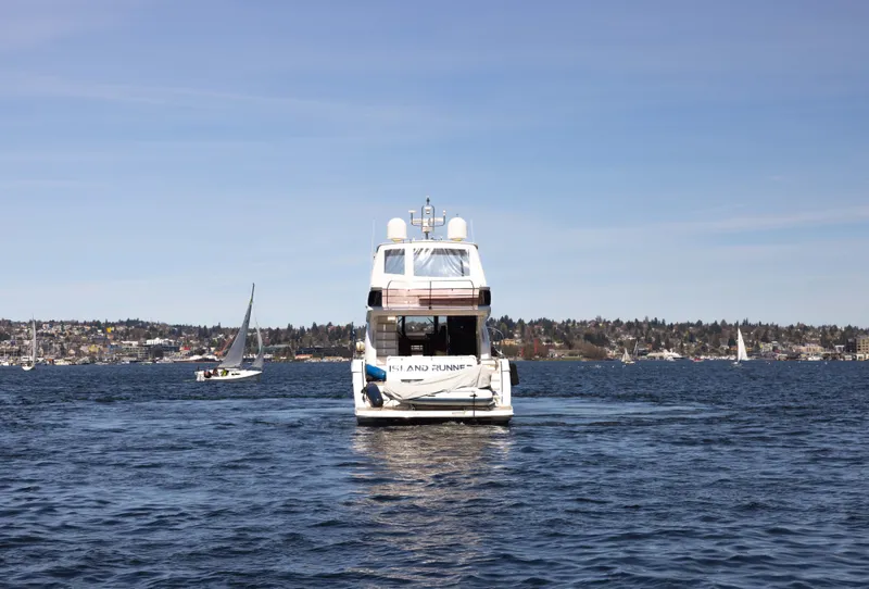 Slide: The Image of Princess 64 Flybridge Yacht 2014 on open water with sailboats. - 8