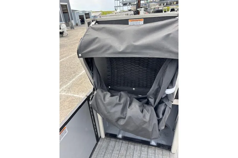 Slide: The Image of 2021 Starcraft SLS 3 boat seat with protective cover in a marina setting. - 31
