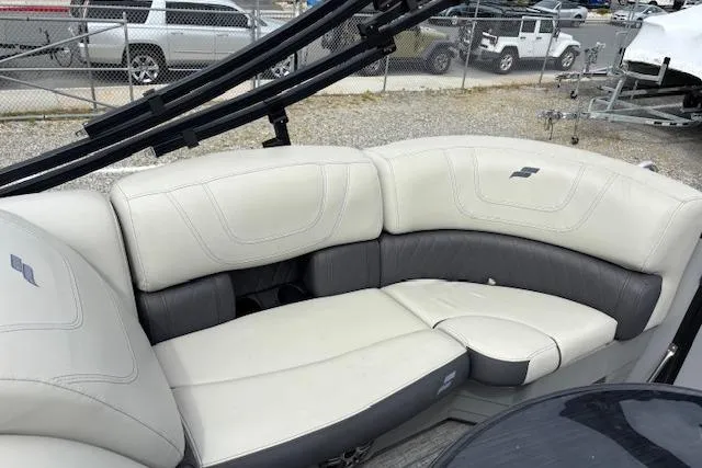 Slide: The Image of Storage compartment in 2021 Starcraft SLS 3 boat with black fenders and cup holders. - 33