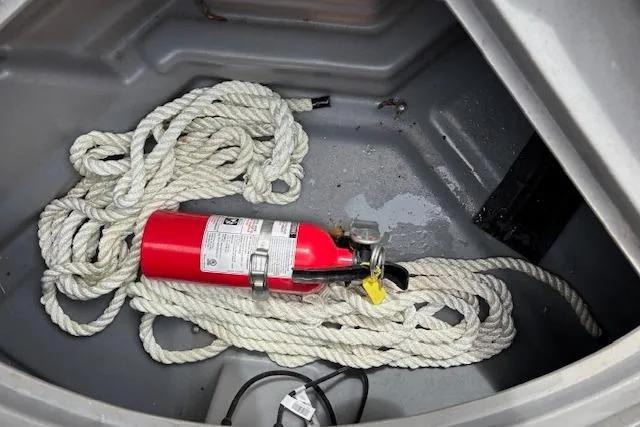 Slide: The Image of Fire extinguisher and rope in 2021 Starcraft SLS 3 boat storage compartment. - 34