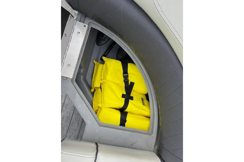 Slide: The Image of Storage compartment in 2021 Starcraft SLS 3 boat with yellow life jackets. - 36
