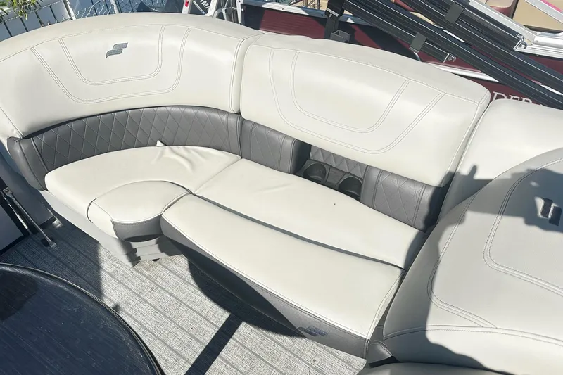 Slide: The Image of 2021 Starcraft SLS 3 boat with Honda outboard motor, docked on a trailer. - 38