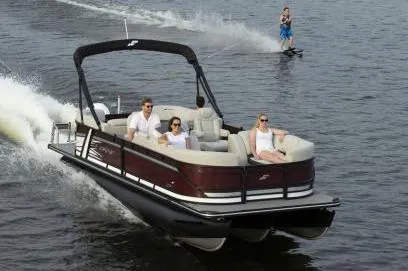 Slide: The Image of Manufacturer Provided Image: 2021 Starcraft SLS 3 pontoon boat cruising with passengers and water skier. - 6