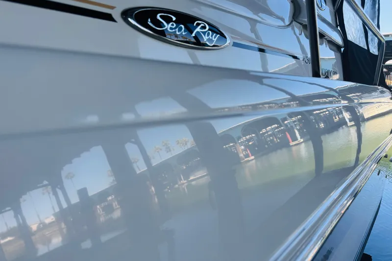 Slide: The Image of 2001 Sea Ray Sundancer 310 boat reflecting marina view on glossy hull. - 12