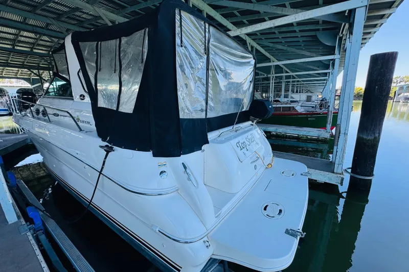 Slide: The Image of 2001 Sea Ray Sundancer 310 docked under a covered marina. - 13
