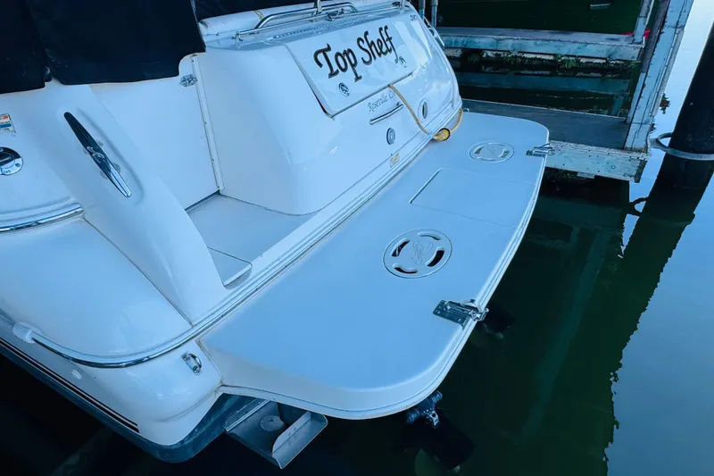 Slide: The Image of 2001 Sea Ray Sundancer 310 boat docked, featuring a spacious swim platform. - 14