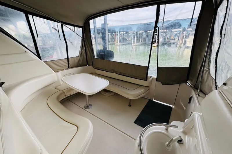 Slide: The Image of Interior of 2001 Sea Ray Sundancer 310 boat with seating and table, docked at marina. - 18