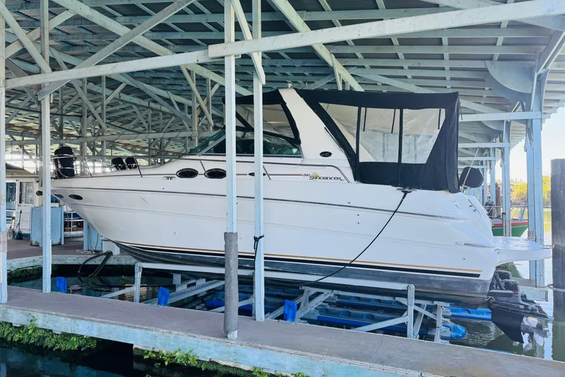 Slide: The Image of 2001 Sea Ray Sundancer 310 yacht docked under covered marina. - 2