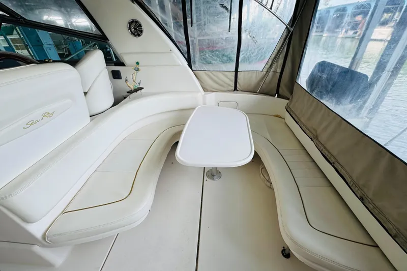 Slide: The Image of Interior of a 2001 Sea Ray Sundancer 310 with white seating and table. - 20