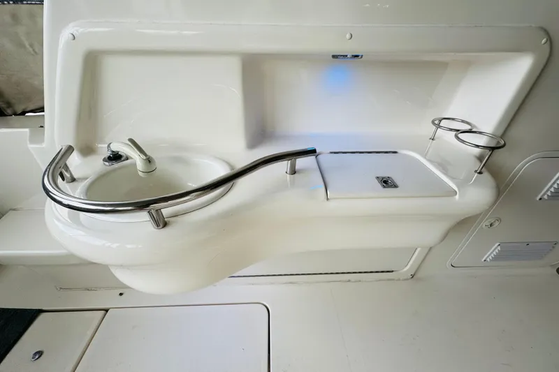 Slide: The Image of 2001 Sea Ray Sundancer 310 boat sink and countertop with cup holders. - 22