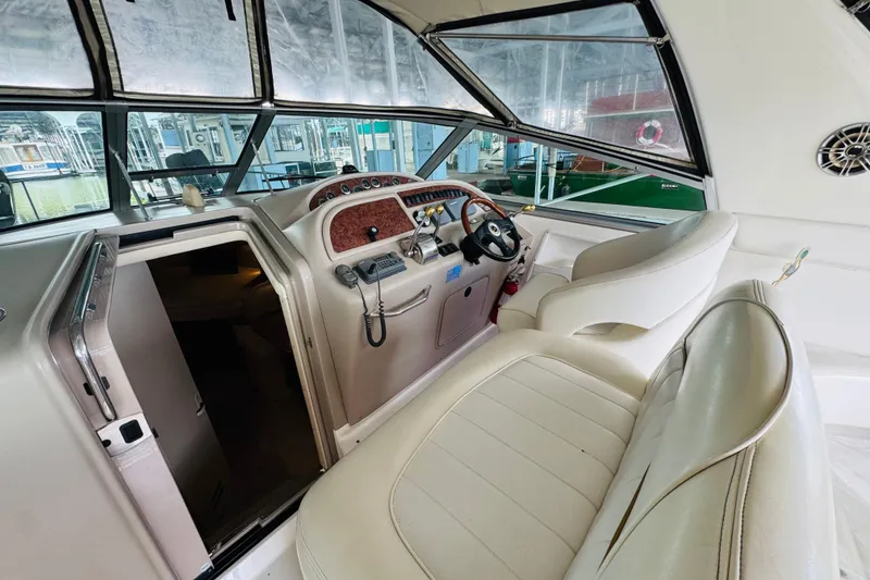 Slide: The Image of Interior view of 2001 Sea Ray Sundancer 310 boat cockpit with steering wheel and seating. - 25