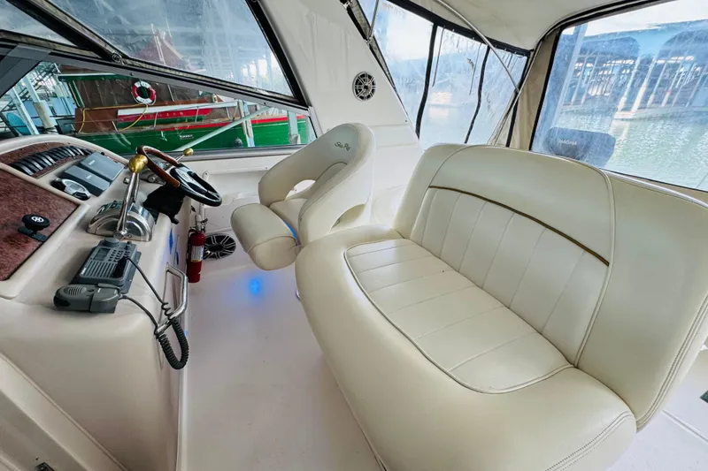 Slide: The Image of Interior of 2001 Sea Ray Sundancer 310 boat with white seating and helm controls. - 26
