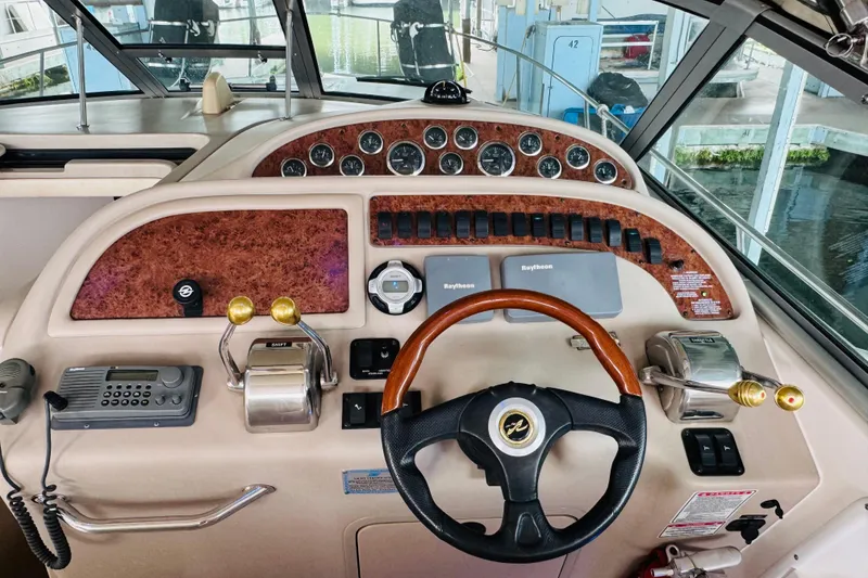 Slide: The Image of Cockpit of 2001 Sea Ray Sundancer 310 with steering wheel and control panel. - 27