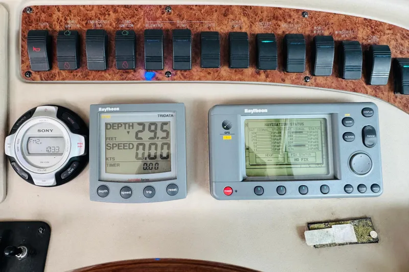 Slide: The Image of Control panel of a 2001 Sea Ray Sundancer 310 with navigation and audio systems. - 28