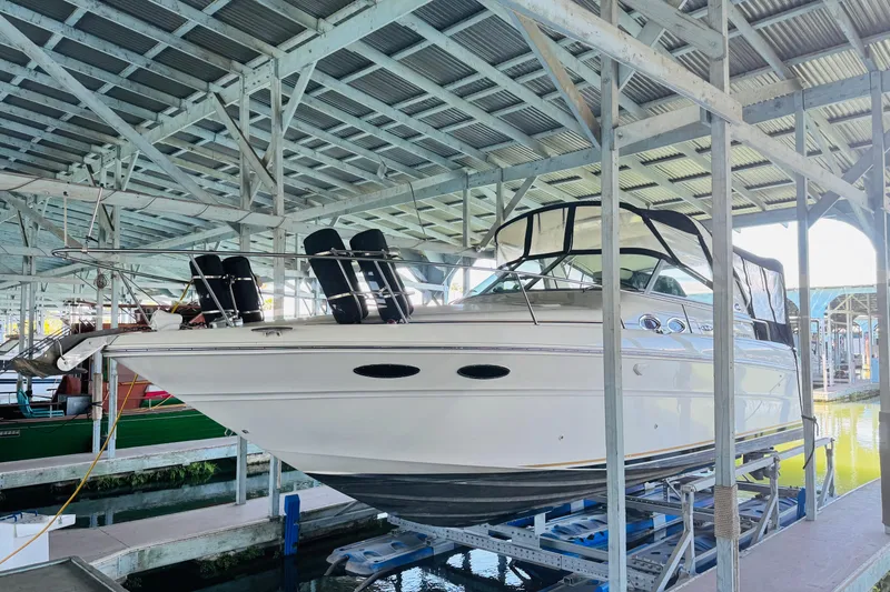 Slide: The Image of 2001 Sea Ray Sundancer 310 yacht docked in a covered marina. - 3