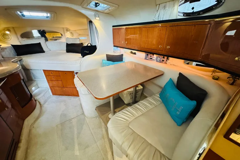 Slide: The Image of Interior of 2001 Sea Ray Sundancer 310, featuring cozy seating and elegant wood cabinetry. - 32