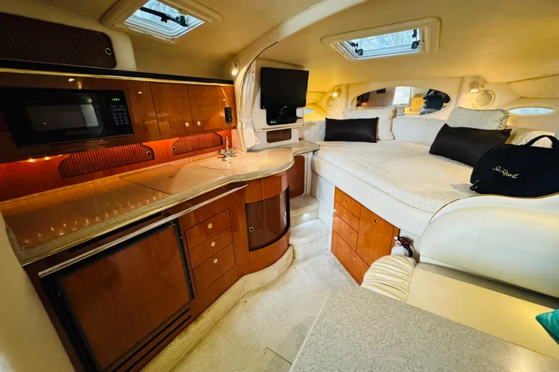 Slide: The Image of Luxurious interior of a 2001 Sea Ray Sundancer 310 yacht with kitchenette and cozy sleeping area. - 33