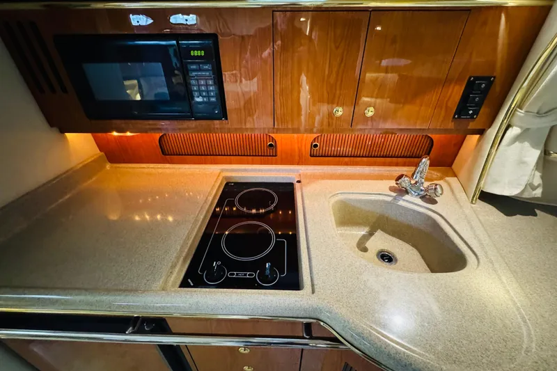 Slide: The Image of 2001 Sea Ray Sundancer 310 galley with microwave, stovetop, and sink. - 39