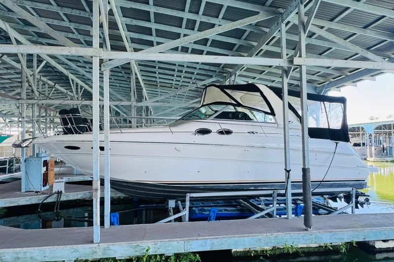 Slide: The Image of 2001 Sea Ray Sundancer 310 yacht docked under a covered marina. - 4