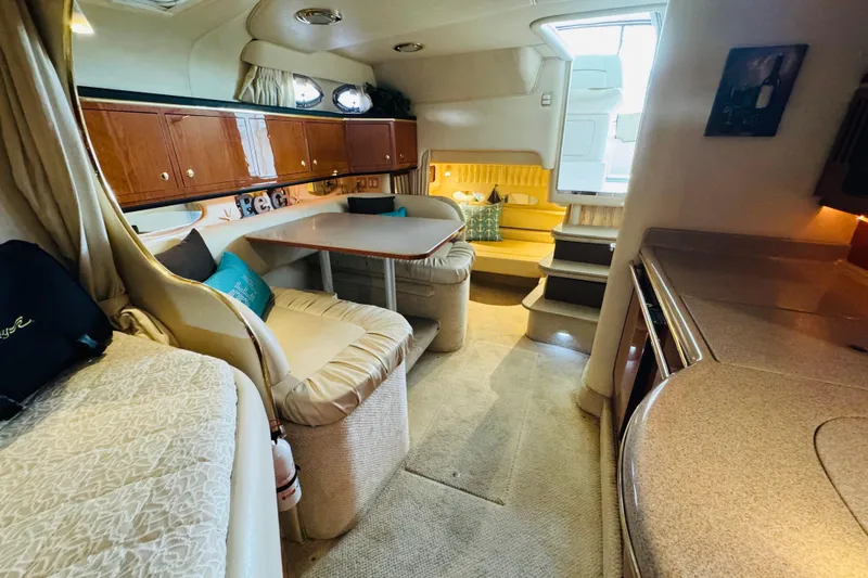 Slide: The Image of 2001 Sea Ray Sundancer 310 interior with cozy seating and elegant wood cabinetry. - 42