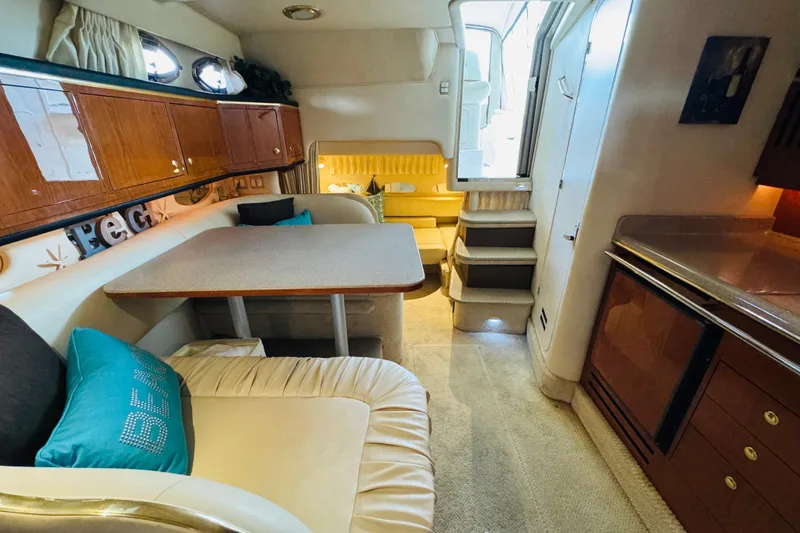 Slide: The Image of Interior of 2001 Sea Ray Sundancer 310 yacht with cozy seating and kitchenette. - 43