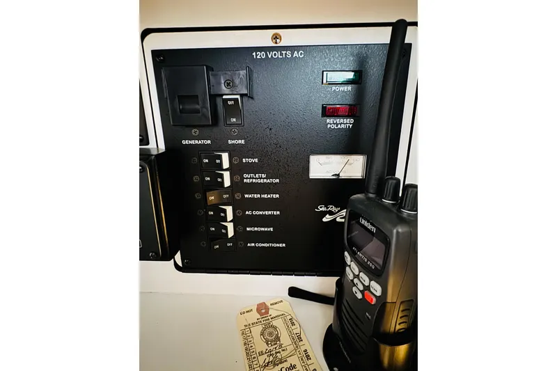 Slide: The Image of Electrical panel of 2001 Sea Ray Sundancer 310 with radio and control switches. - 44