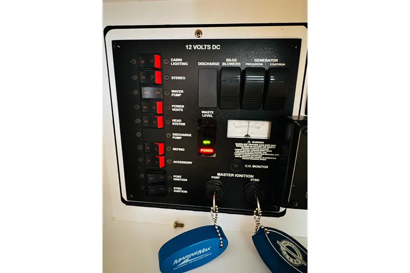 Slide: The Image of 2001 Sea Ray Sundancer 310 control panel with switches and ignition keys. - 45