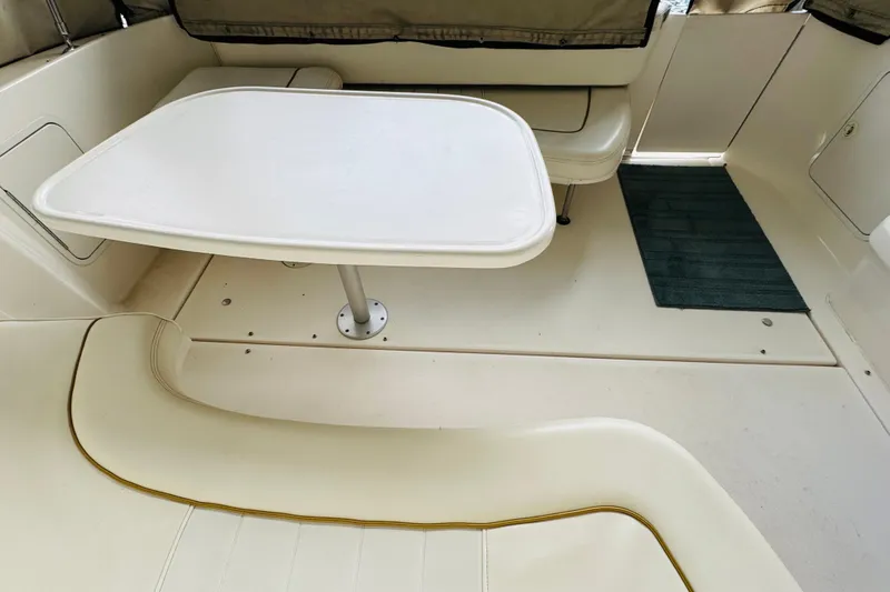 Slide: The Image of Interior seating area of a 2001 Sea Ray Sundancer 310 boat with table. - 47