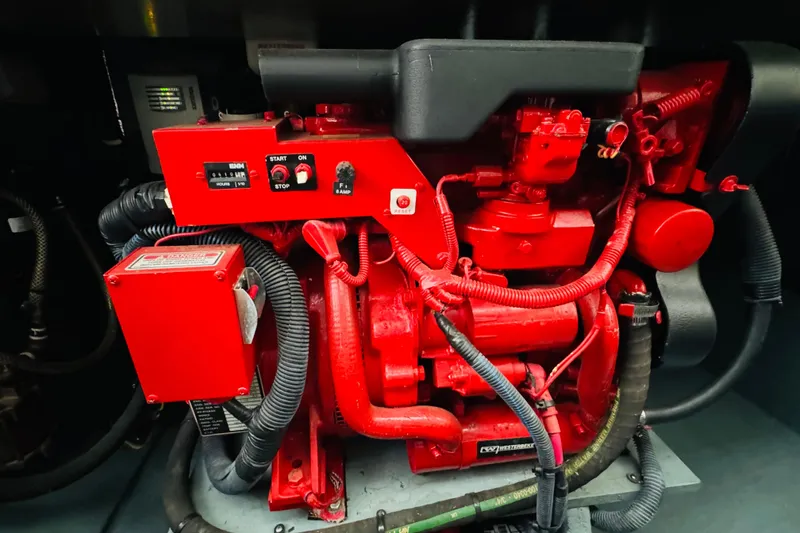 Slide: The Image of Engine compartment of a 2001 Sea Ray Sundancer 310 with red mechanical components. - 51