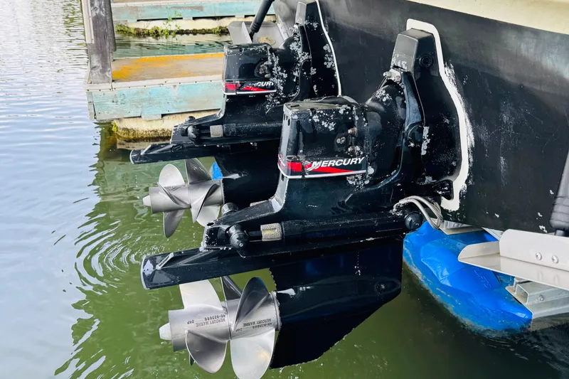 Slide: The Image of Twin Mercury outboard engines on a 2001 Sea Ray Sundancer 310 boat. - 53
