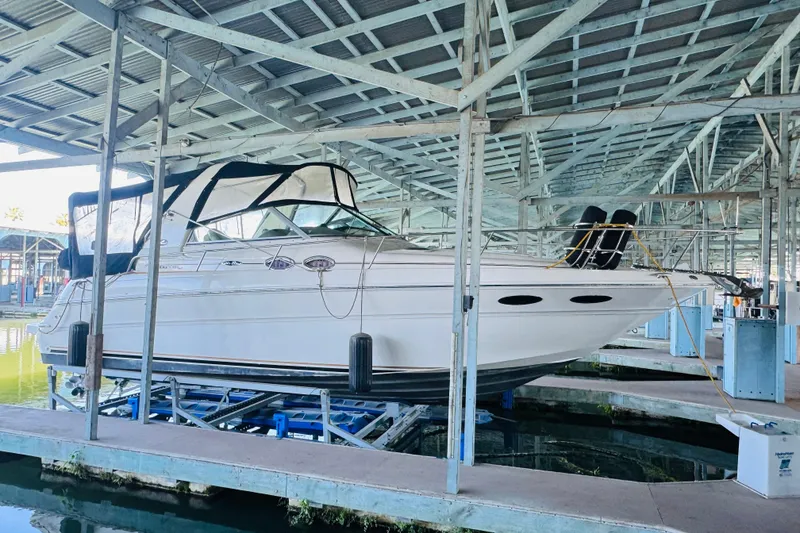 Slide: The Image of 2001 Sea Ray Sundancer 310 yacht docked in a covered marina. - 6