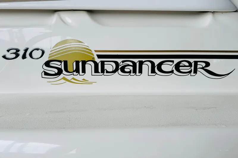 Slide: The Image of 2001 Sea Ray Sundancer 310 logo on boat exterior. - 61