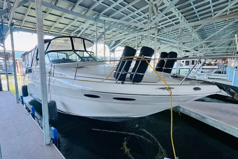 Slide: The Image of 2001 Sea Ray Sundancer 310 yacht docked in a covered marina. - 8