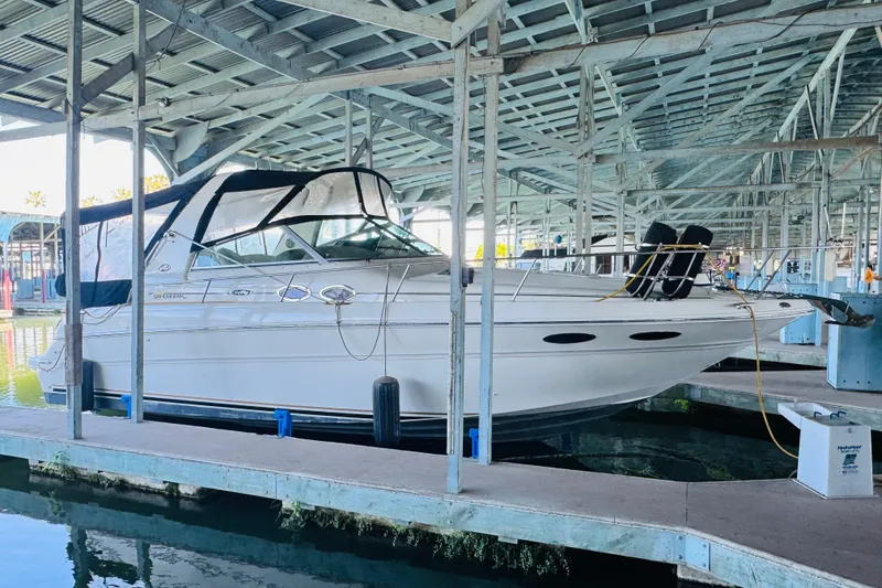 Slide: The Image of 2001 Sea Ray Sundancer 310 docked in a covered marina, side view. - 9