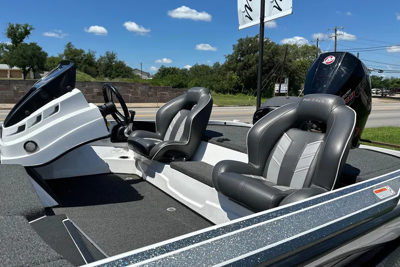 Slide: The Image of 2021 Nitro Z18 boat interior with sleek seats and modern dashboard under clear skies. - 11