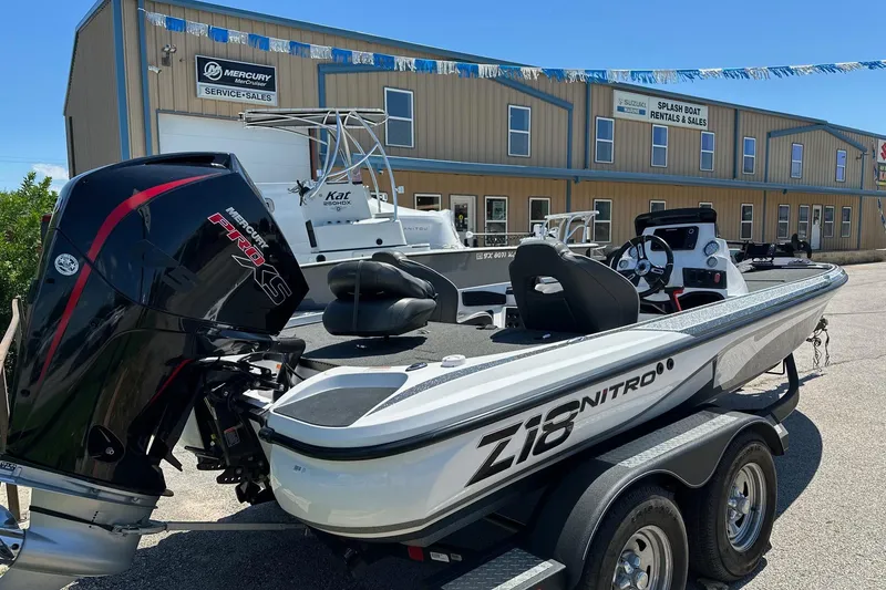 Slide: The Image of 2021 Nitro Z18 boat with Mercury engine at dealership, showcasing sleek design and features. - 3