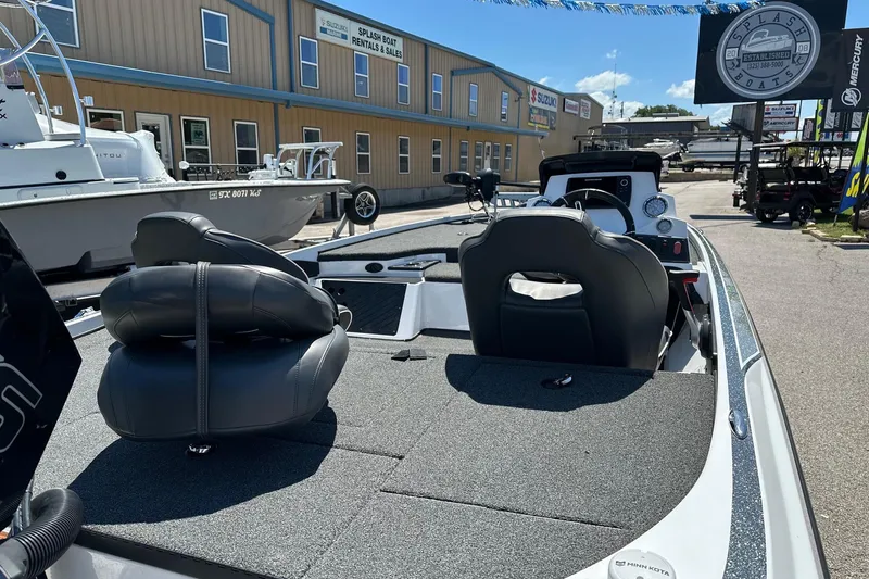 Slide: The Image of 2021 Nitro Z18 boat interior at dealership, featuring seating and control panel. - 4