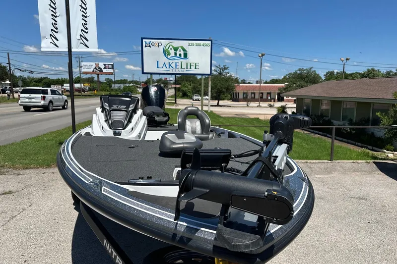 Slide: The Image of 2021 Nitro Z18 boat displayed outdoors near Lakelife Team sign. - 8