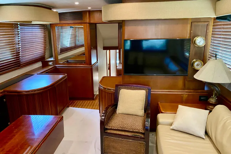 Slide: The Image of Luxurious interior of a 1986 Huckins Sport Fisherman yacht with wood paneling and modern amenities. - 17